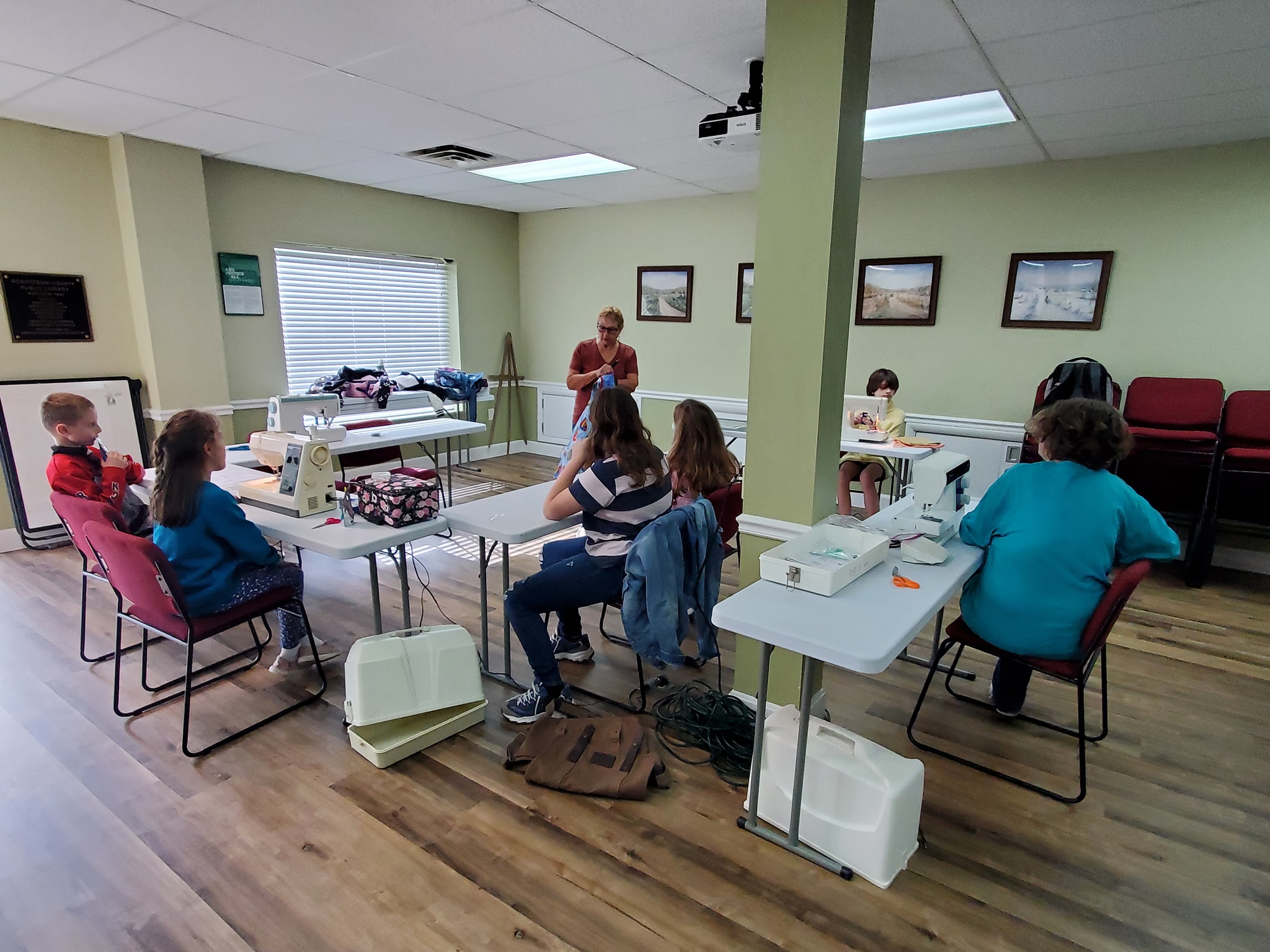 Sewing club members learning to sew