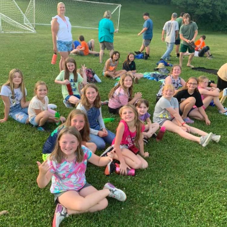  4-H campers sitting on the ground